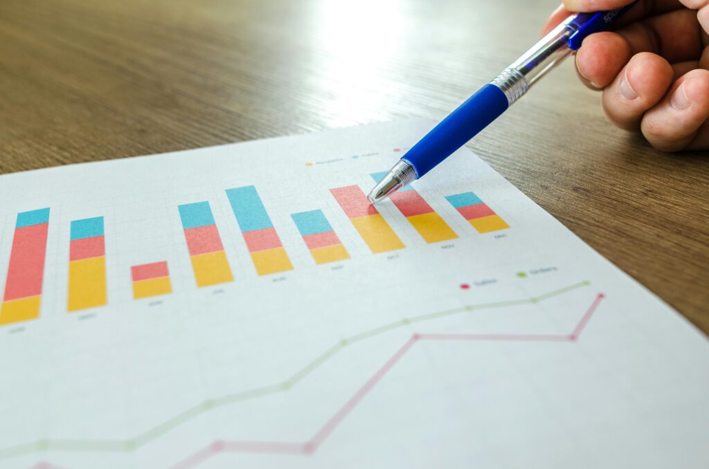 A person pointing at a graph with a pen