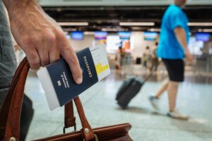 Digital Identity In 2026: The Quiet End Of The Anonymous Account Hand holding a passport